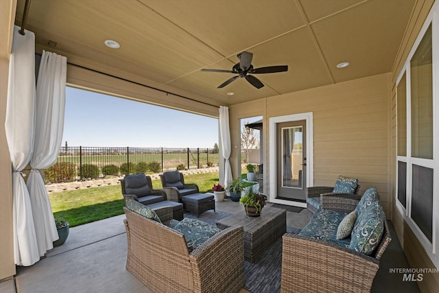 view of patio with outdoor lounge area, fence, and ceiling fan