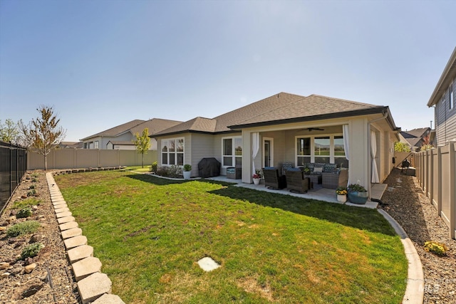 back of property featuring a fenced backyard, a ceiling fan, a lawn, an outdoor hangout area, and a patio