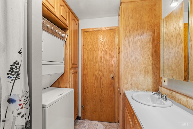 laundry room featuring stacked washer and dryer and sink