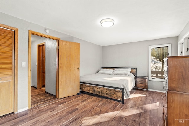 bedroom with dark wood-type flooring