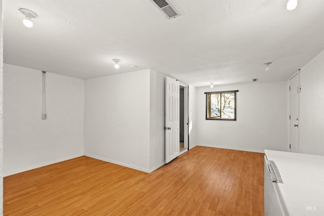 spare room featuring light wood-type flooring