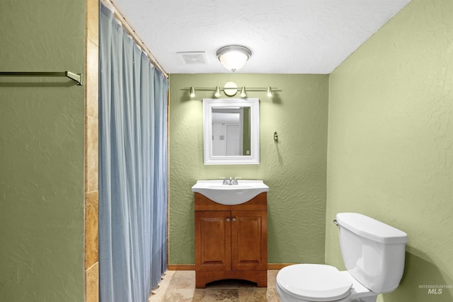 bathroom with vanity, toilet, and walk in shower