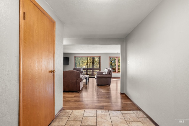 hallway with light hardwood / wood-style flooring