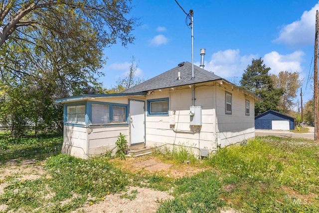 view of front of home with entry steps, a shingled roof, and a garage