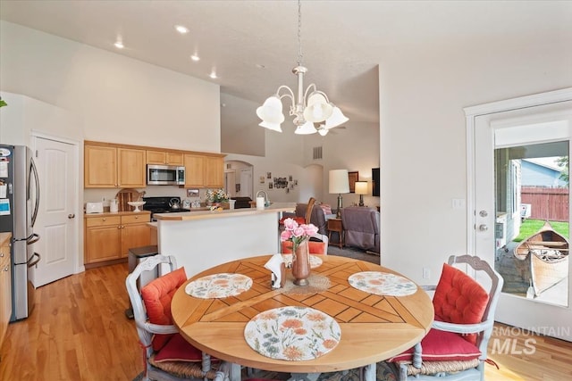 562 Castle Rock Ave, Middleton, ID 83644 - dining area featuring a chandelier, high vaulted ceiling, light wood-style flooring, and recessed lighting