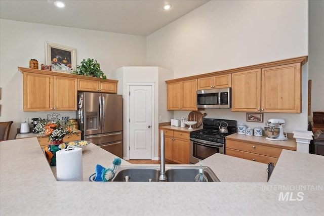 562 Castle Rock Ave, Middleton, ID 83644 - kitchen featuring stainless steel appliances, a sink, light countertops, a high ceiling, and recessed lighting