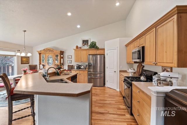 562 Castle Rock Ave, Middleton, ID 83644 - kitchen with appliances with stainless steel finishes, a sink, light wood-type flooring, light countertops, and recessed lighting