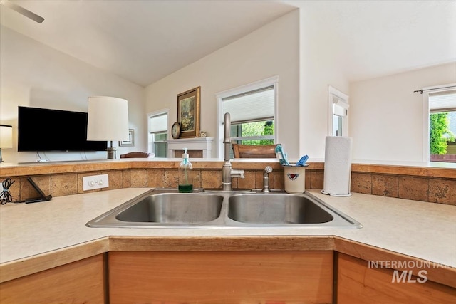 562 Castle Rock Ave, Middleton, ID 83644 - kitchen featuring a sink, light countertops, vaulted ceiling, and open floor plan