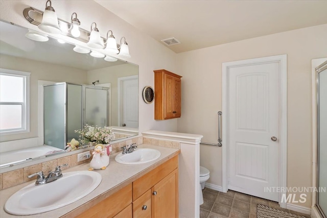 562 Castle Rock Ave, Middleton, ID 83644 - full bathroom featuring a shower stall, double vanity, toilet, and tile patterned flooring