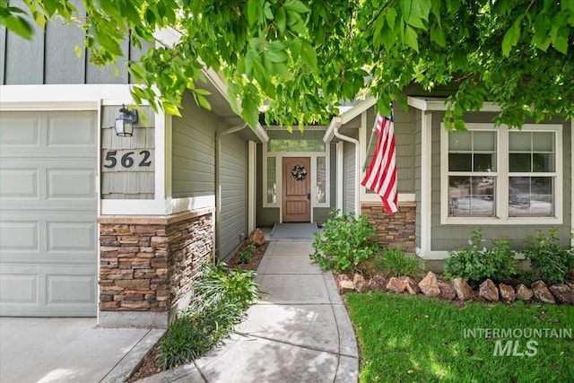 562 Castle Rock Ave, Middleton, ID 83644 - view of exterior entry with stone siding and a garage