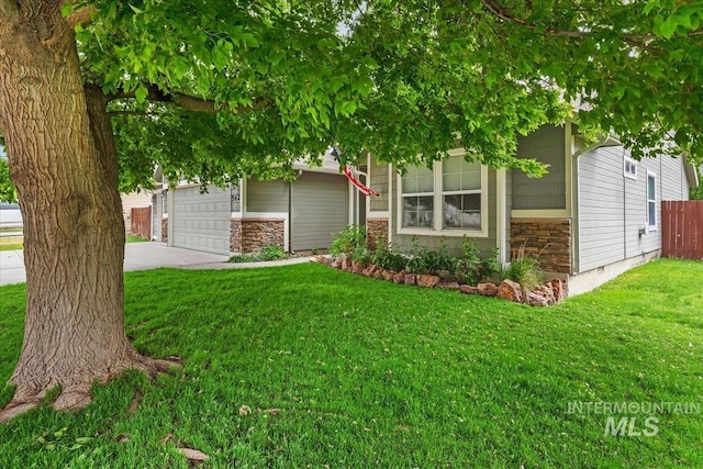 562 Castle Rock Ave, Middleton, ID 83644 - view of property hidden behind natural elements featuring driveway, an attached garage, and stone siding