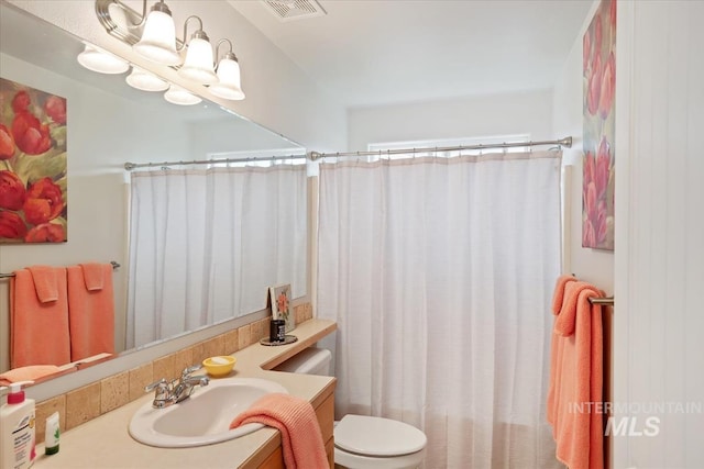 562 Castle Rock Ave, Middleton, ID 83644 - bathroom featuring vanity, toilet, and a shower with shower curtain