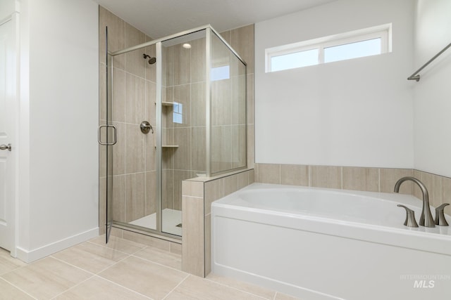 bathroom with tile patterned flooring and shower with separate bathtub