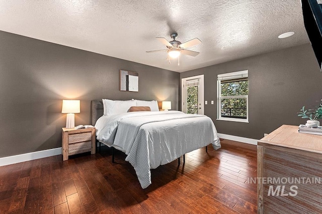 bedroom with dark wood-style flooring, baseboards, access to outside, ceiling fan, and a textured ceiling