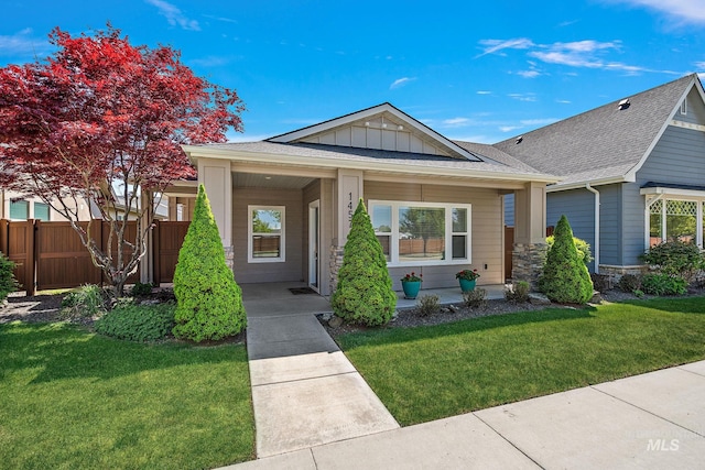 1457 Summerheights, Meridian, ID 83646 - view of front facade with a front lawn, fence, stone siding, roof with shingles, and board and batten siding
