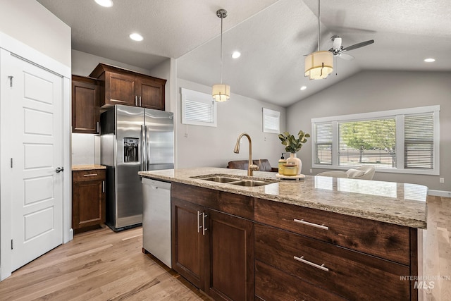 1457 Summerheights, Meridian, ID 83646 - kitchen featuring ceiling fan, a sink, light wood finished floors, vaulted ceiling, and stainless steel appliances