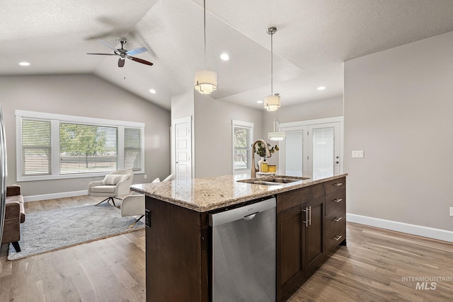 1457 Summerheights, Meridian, ID 83646 - kitchen featuring light wood-type flooring, dark brown cabinets, a sink, dishwasher, and open floor plan