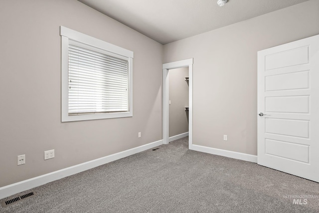 1457 Summerheights, Meridian, ID 83646 - unfurnished bedroom featuring carpet floors, baseboards, a walk in closet, and visible vents