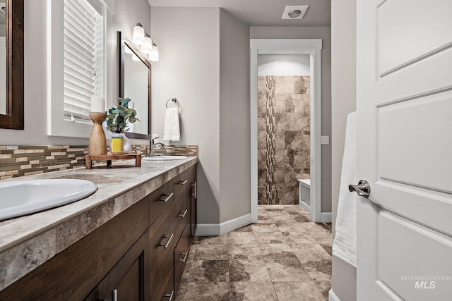 1457 Summerheights, Meridian, ID 83646 - bathroom with double vanity, visible vents, a sink, baseboards, and tiled shower