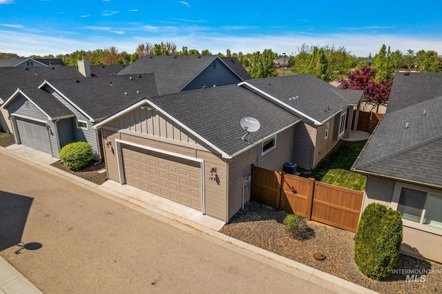 1457 Summerheights, Meridian, ID 83646 - view of front of house with board and batten siding, roof with shingles, a residential view, a garage, and fence