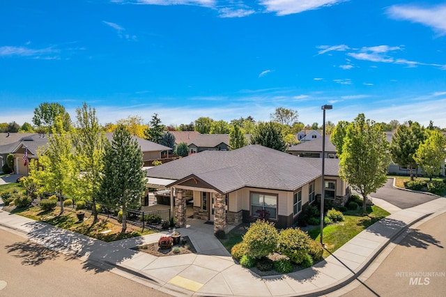 1457 Summerheights, Meridian, ID 83646 - view of front of property with fence, stone siding, a shingled roof, a porch, and a residential view