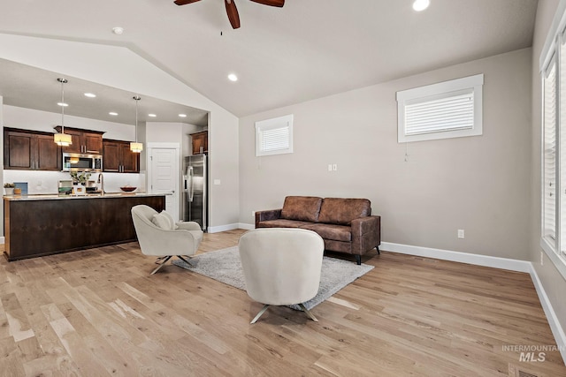 1457 Summerheights, Meridian, ID 83646 - living area featuring a ceiling fan, vaulted ceiling, and light wood-type flooring