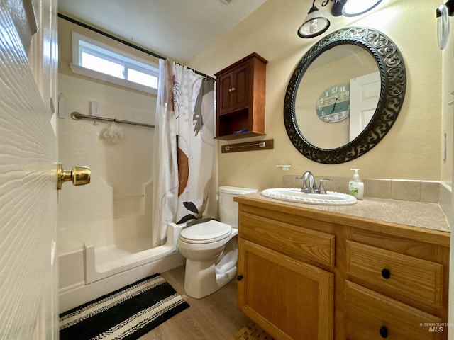 bathroom with vanity, hardwood / wood-style floors, and toilet