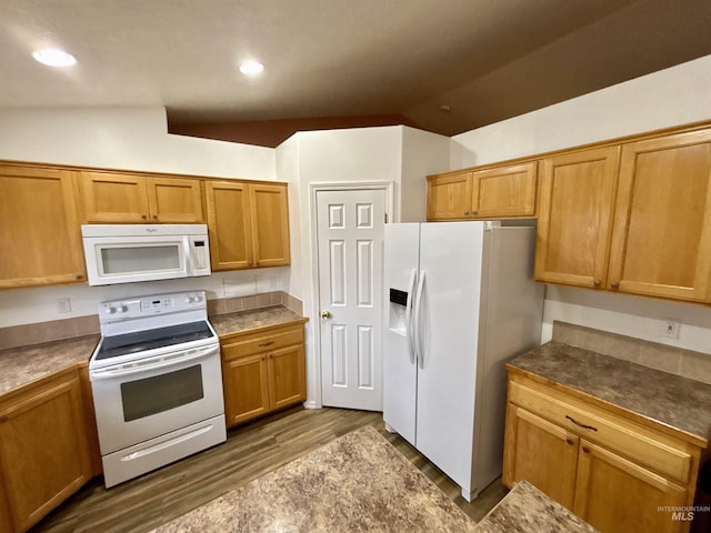 kitchen with dark hardwood / wood-style flooring, white appliances, and lofted ceiling