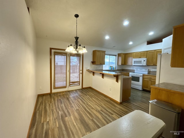 kitchen with dark hardwood / wood-style floors, a breakfast bar, hanging light fixtures, kitchen peninsula, and white appliances