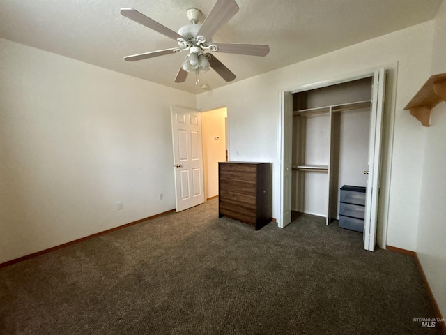 unfurnished bedroom with dark carpet, a closet, and ceiling fan