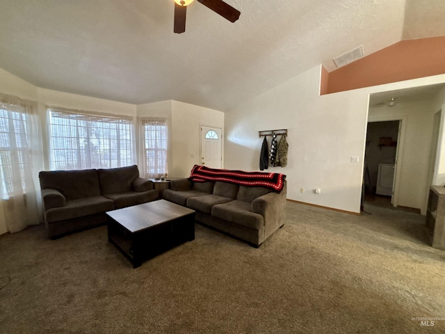 living room with washer / dryer, lofted ceiling, carpet flooring, ceiling fan, and a textured ceiling