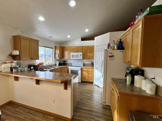 kitchen with a kitchen breakfast bar, dark hardwood / wood-style flooring, white appliances, and kitchen peninsula