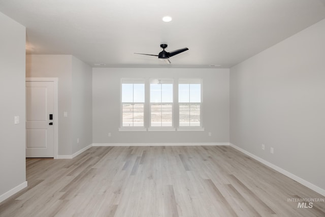 spare room featuring ceiling fan and light hardwood / wood-style flooring