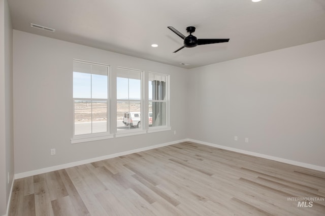 spare room with ceiling fan and light hardwood / wood-style flooring