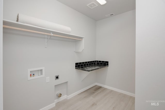 washroom featuring light wood-type flooring, hookup for a washing machine, and hookup for an electric dryer