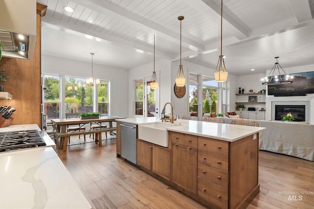 kitchen featuring beam ceiling, dishwasher, decorative light fixtures, and sink