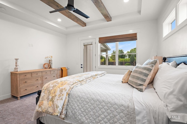 carpeted bedroom featuring beam ceiling and ceiling fan