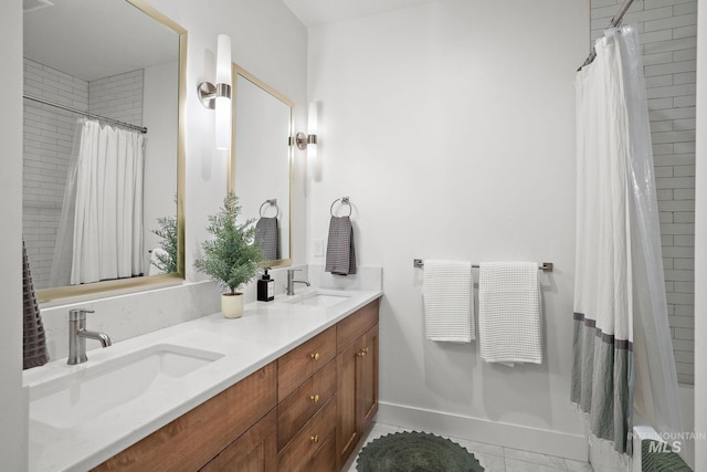 bathroom featuring curtained shower, tile patterned flooring, and vanity