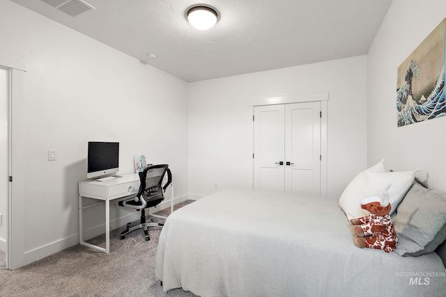 bedroom featuring a closet and light colored carpet