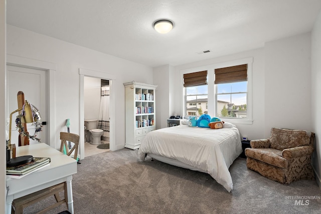 carpeted bedroom with connected bathroom