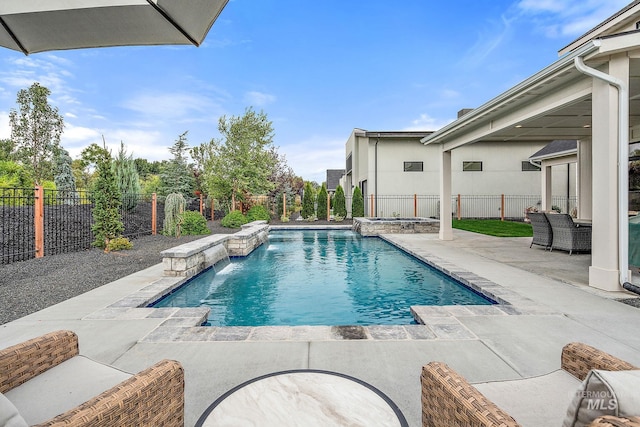 view of swimming pool featuring an in ground hot tub, pool water feature, and a patio