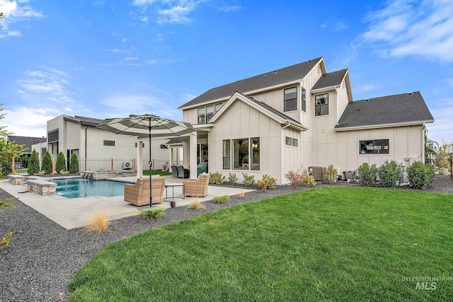 back of house featuring a lawn, a pool with hot tub, a patio, and central AC