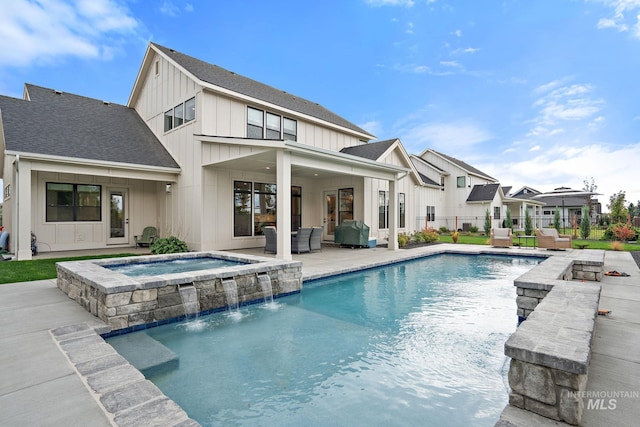 view of pool featuring a patio area, an in ground hot tub, pool water feature, and an outdoor hangout area