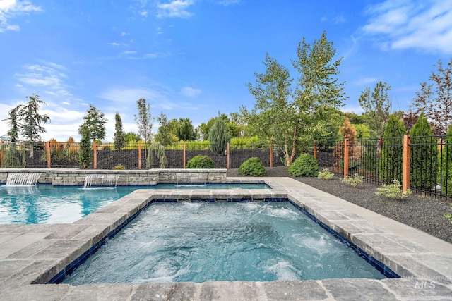 view of swimming pool with an in ground hot tub and pool water feature