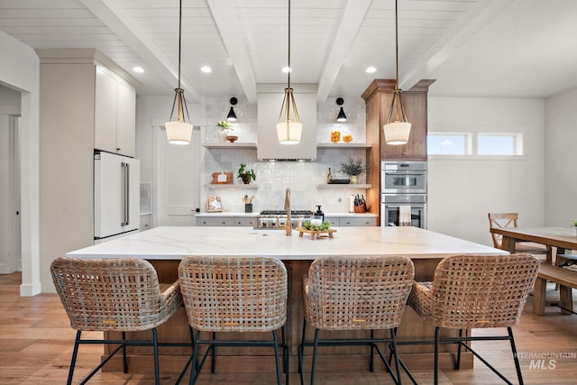 kitchen featuring pendant lighting, double oven, tasteful backsplash, beam ceiling, and high end white refrigerator