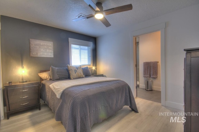 1501 S Hervey St, Boise, ID 83705 - bedroom featuring light wood-style flooring, ceiling fan, a textured ceiling, baseboards, and connected bathroom