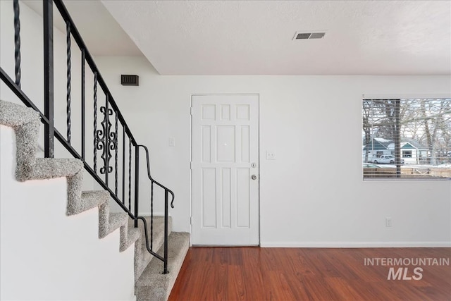 entrance foyer featuring hardwood / wood-style flooring and a textured ceiling