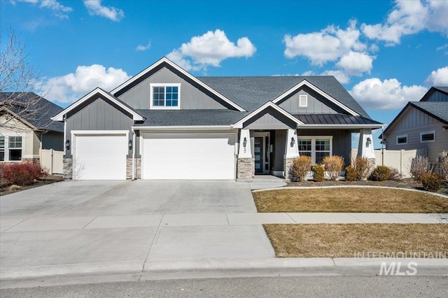 craftsman-style house with metal roof, fence, driveway, a standing seam roof, and a front yard