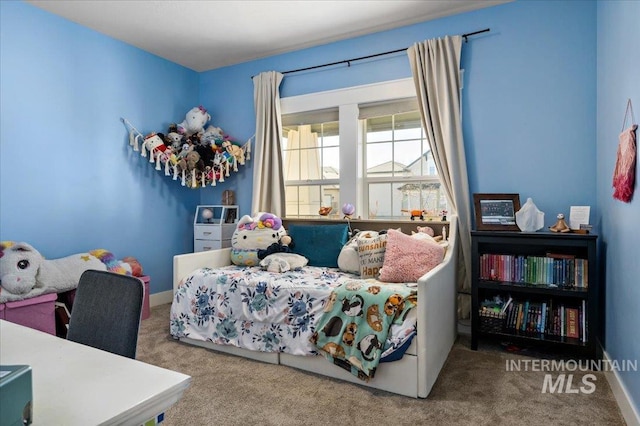 carpeted bedroom featuring baseboards