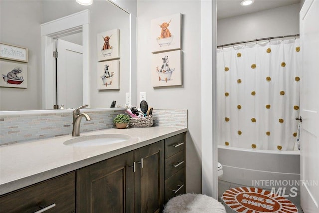 full bath with toilet, shower / tub combo, backsplash, and vanity